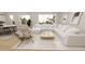 Spacious living room featuring a plush white sectional, wood floors, and natural light at 410 Chatham View Rd, Cary, NC 27511