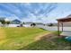 Grassy backyard with shed, privacy fence, and covered patio at 4109 Massey Preserve Trl, Raleigh, NC 27616
