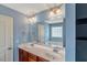Bathroom features double sinks, vanity with drawers, a large mirror, and modern fixtures at 4109 Massey Preserve Trl, Raleigh, NC 27616
