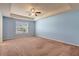 Bedroom featuring neutral carpet, a ceiling fan and blue walls at 4109 Massey Preserve Trl, Raleigh, NC 27616