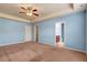 Bedroom features a ceiling fan, blue walls and en suite bathroom at 4109 Massey Preserve Trl, Raleigh, NC 27616