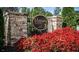 Stone pillars welcome you to the Massey Preserve, complemented by vibrant red flowers and lush greenery at 4109 Massey Preserve Trl, Raleigh, NC 27616