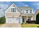 Inviting two-story home showcasing a well-kept lawn and attached two-car garage at 4109 Massey Preserve Trl, Raleigh, NC 27616