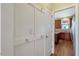 Hallway with coat hooks leading to an updated kitchen with granite countertops at 4109 Massey Preserve Trl, Raleigh, NC 27616