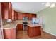 Kitchen with stainless steel appliances, granite counters, island, and stylish wood cabinets at 4109 Massey Preserve Trl, Raleigh, NC 27616