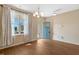 Bright living room features wood floors, large window, and neutral paint at 4109 Massey Preserve Trl, Raleigh, NC 27616