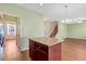 View of the Living Room from the kitchen with hardwood floors and a granite counter island at 4109 Massey Preserve Trl, Raleigh, NC 27616