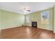 Bright living room features a fireplace, hardwood floors, and a large window at 4109 Massey Preserve Trl, Raleigh, NC 27616