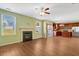 Open living room with fireplace, hardwood floors, lots of sunlight, and view of the kitchen at 4109 Massey Preserve Trl, Raleigh, NC 27616