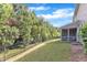 Green backyard with black fencing and view of the screened-in porch on the back of the house at 416 Durants Neck Ln, Morrisville, NC 27560