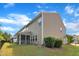 Exterior of house with tan siding, screened-in porch, green grass, and bushes in the backyard at 416 Durants Neck Ln, Morrisville, NC 27560