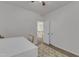 Bedroom with neutral carpet and decor features an adjoining hallway visible through an open doorway at 416 Durants Neck Ln, Morrisville, NC 27560