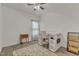Bedroom features neutral decor, a ceiling fan, and desk area with chair; area rug adds warmth at 416 Durants Neck Ln, Morrisville, NC 27560