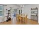 Bright dining area features wood floors, stylish chandelier, and sliding glass doors at 416 Durants Neck Ln, Morrisville, NC 27560