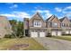 Well-maintained townhomes with brick facades, double garages, and established landscaping at 416 Durants Neck Ln, Morrisville, NC 27560