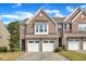Charming brick townhome with a two-car garage and well-maintained landscaping at 416 Durants Neck Ln, Morrisville, NC 27560
