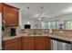 Eat in kitchen area showcasing stainless steel dishwasher, granite countertops and hardwood floors at 416 Durants Neck Ln, Morrisville, NC 27560