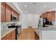 Modern kitchen featuring stainless steel appliances, granite counters, and ample cabinet space at 416 Durants Neck Ln, Morrisville, NC 27560