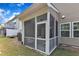Back of house features a screened-in porch overlooking the backyard with green grass at 416 Durants Neck Ln, Morrisville, NC 27560
