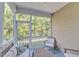 Relaxing screened porch with white trim, view of backyard, and seating area with wooden table at 416 Durants Neck Ln, Morrisville, NC 27560