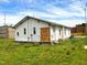 An exterior shot of the back of a home featuring grass and boarded-up windows at 422 Nance St, Rocky Mount, NC 27803