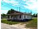 A cozy home exhibits character, complemented by mature trees and an expansive sky at 422 Nance St, Rocky Mount, NC 27803