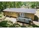 Aerial view of home exterior, deck and yard surrounded by mature trees at 4221 River Run Dr, Sanford, NC 27332