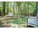 Backyard view from deck with shed in the distance surrounded by mature shade trees at 4221 River Run Dr, Sanford, NC 27332