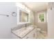 A bathroom features a granite vanity, a rectangular mirror and a toilet underneath a window at 4221 River Run Dr, Sanford, NC 27332