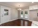Bright dining area with French doors leading to a deck or patio and a modern chandelier at 4221 River Run Dr, Sanford, NC 27332