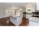 Open kitchen features an island, stainless steel appliances, granite countertops, and dark backsplash at 4221 River Run Dr, Sanford, NC 27332