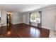 Bright living room featuring hardwood floors and an open layout connecting the kitchen and dining areas at 4221 River Run Dr, Sanford, NC 27332
