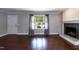Open living room with hardwood floors, fireplace, and natural light from a backyard window at 4221 River Run Dr, Sanford, NC 27332