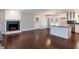 Open-concept living space combining living room, dining area, and kitchen with hardwood floors and a fireplace at 4221 River Run Dr, Sanford, NC 27332