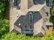 An aerial view shows the roof of the house with a small deck and partial tree coverage at 445 Ridge Springs Dr, Chapel Hill, NC 27516