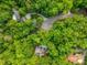 An aerial view of a house in a neighborhood with lush greenery and a pool visible at 445 Ridge Springs Dr, Chapel Hill, NC 27516