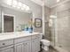 Elegant bathroom features a vanity with double sinks, a large mirror, and a glass-enclosed shower at 445 Ridge Springs Dr, Chapel Hill, NC 27516