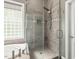 Modern bathroom with a glass-enclosed shower, rain shower head, and tile surround at 445 Ridge Springs Dr, Chapel Hill, NC 27516