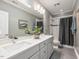 Modern bathroom features double sinks, quartz countertop, tub, and shower for a spa-like experience at 445 Ridge Springs Dr, Chapel Hill, NC 27516