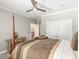 This comfortable bedroom features soft carpet, neutral colors, and a ceiling fan at 445 Ridge Springs Dr, Chapel Hill, NC 27516