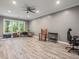 Large bonus room with gray walls, wood floors, ceiling fan and lots of natural light at 445 Ridge Springs Dr, Chapel Hill, NC 27516