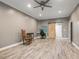 Home office with gray walls, wood floors, ceiling fan and barn door at 445 Ridge Springs Dr, Chapel Hill, NC 27516