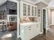 Charming butler's pantry with white cabinetry, glass uppers, and a mosaic tile backsplash in a cozy home at 445 Ridge Springs Dr, Chapel Hill, NC 27516