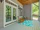 Cozy covered deck featuring patio furniture, an outdoor rug, and views of the greenery at 445 Ridge Springs Dr, Chapel Hill, NC 27516