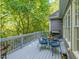 Charming deck offering a tranquil outdoor space with table and chairs, surrounded by lush greenery at 445 Ridge Springs Dr, Chapel Hill, NC 27516