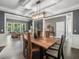 Elegant dining room featuring coffered ceiling, modern lighting, and views into the living room at 445 Ridge Springs Dr, Chapel Hill, NC 27516
