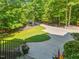 View of circular driveway and lush, mature landscaping around this stunning property at 445 Ridge Springs Dr, Chapel Hill, NC 27516