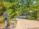 View of the driveway leading up to the house, complemented by a mailbox and surrounding landscape at 445 Ridge Springs Dr, Chapel Hill, NC 27516