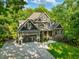 Charming home with a beautifully landscaped front yard, attached garage, and stone and wood facade at 445 Ridge Springs Dr, Chapel Hill, NC 27516