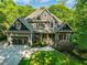 Charming home with a beautifully landscaped front yard, attached garage, and stone and wood facade at 445 Ridge Springs Dr, Chapel Hill, NC 27516